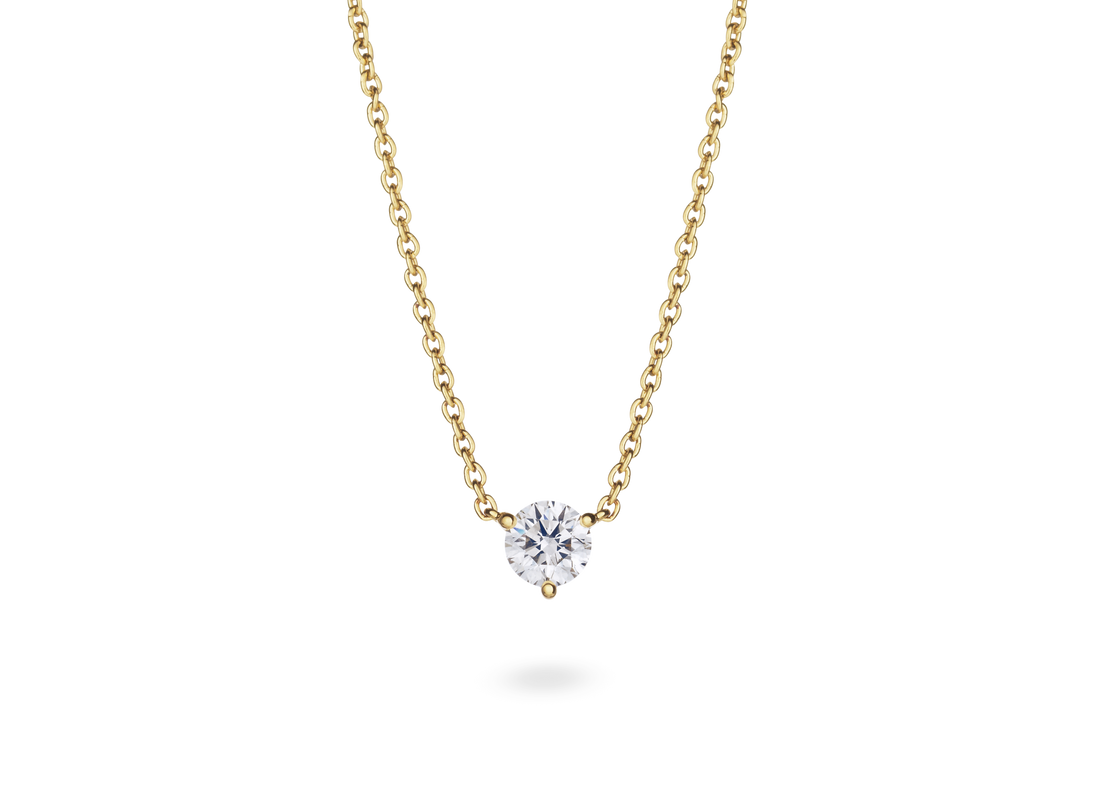 Front view of a white 0.5 carat round brilliant solitaire pendant in 14k yellow gold